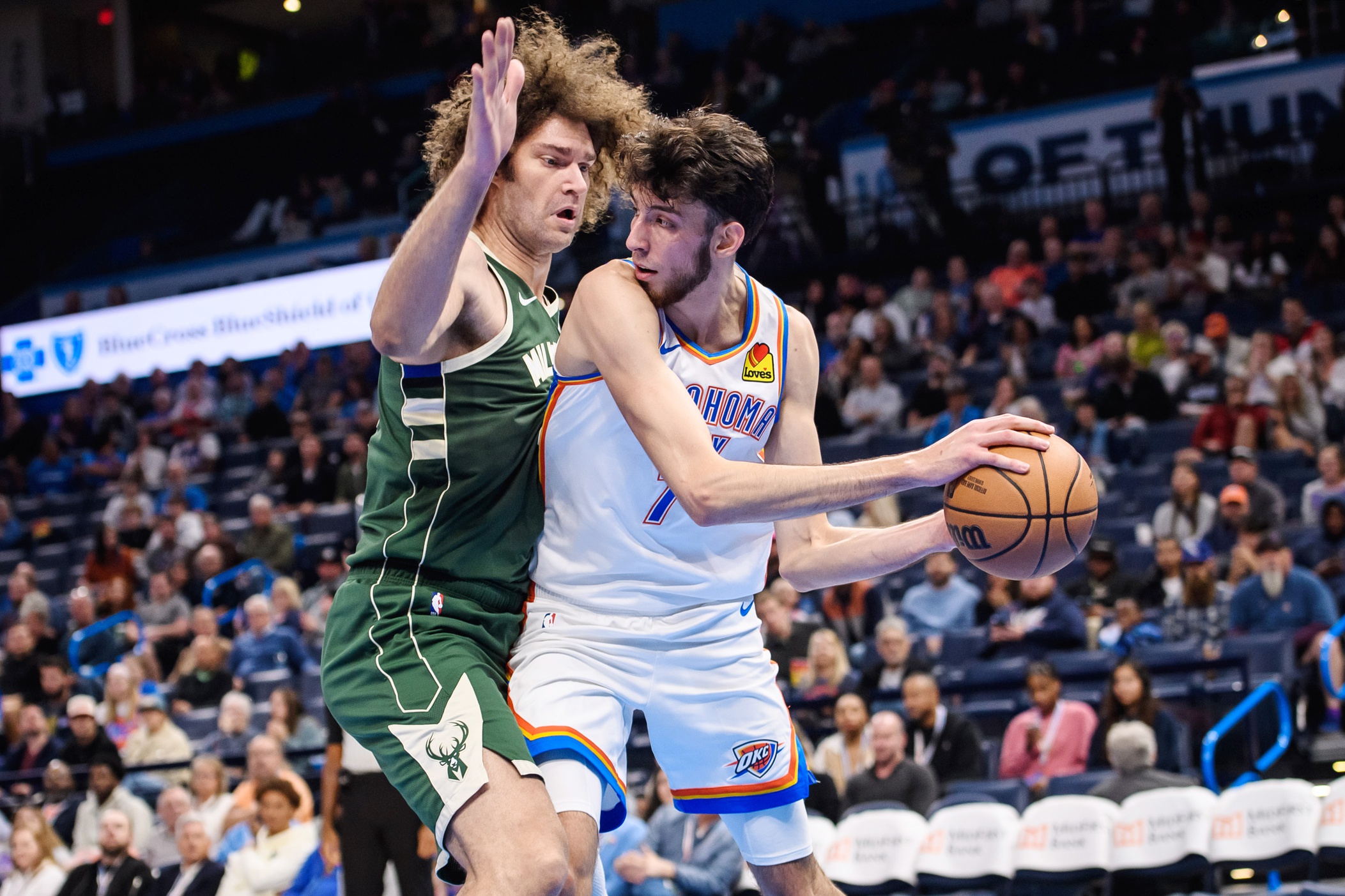 Oct 17, 2023; Oklahoma City, Oklahoma, USA; Oklahoma City Thunder forward Chet Holmgren (7) fights for position while defended by Milwaukee Bucks center Robin Lopez (42) during the first half at Paycom Center. Mandatory Credit: Rob Ferguson-USA TODAY Sports