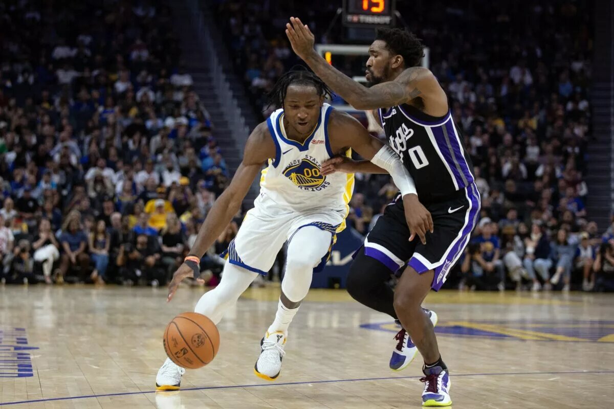 Oct 18, 2023; San Francisco, California, USA; Golden State Warriors forward Jonathan Kuminga (00) drives past Sacramento Kings guard Malik Monk (0) during the fourth quarter at Chase Center. Mandatory Credit: D. Ross Cameron-USA TODAY Sports