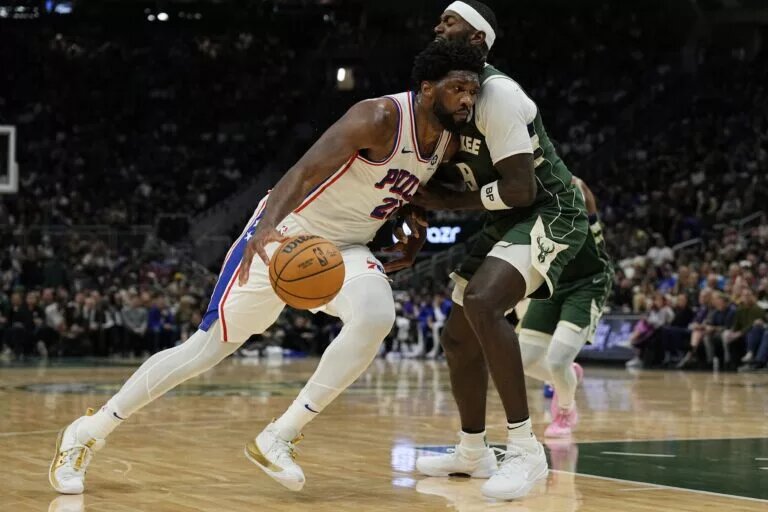 Oct 26, 2023; Milwaukee, Wisconsin, USA; Philadelphia 76ers center Joel Embiid (21) drives for the basket against Milwaukee Bucks forward Bobby Portis (9) during the third quarter at Fiserv Forum. Mandatory Credit: Jeff Hanisch-USA TODAY Sports