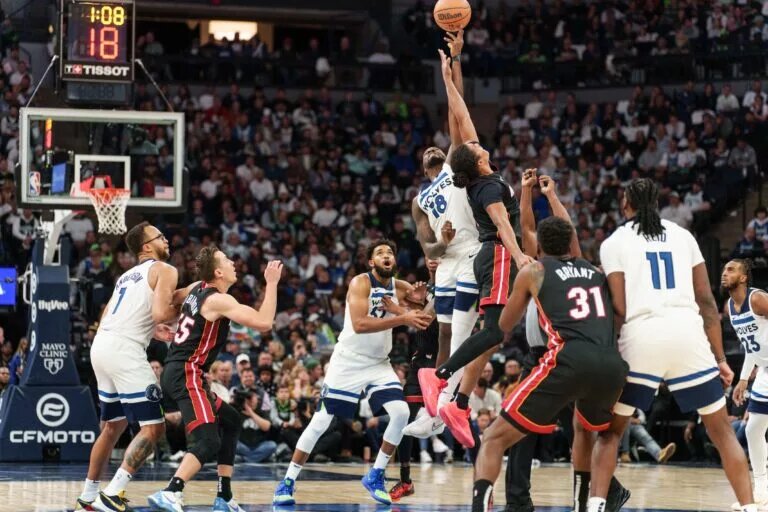 Oct 28, 2023; Minneapolis, Minnesota, USA; Minnesota Timberwolves guard Shake Milton (18) wins the jump ball against Miami Heat guard Dru Smith (9) in the third quarter at Target Center. Mandatory Credit: Matt Blewett-USA TODAY Sports