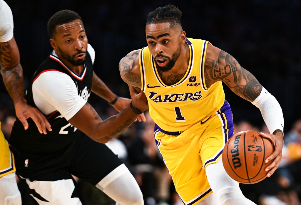 Los Angeles Lakers guard D'Angelo Russell (1) dribbles the ball against LA Clippers guard Norman Powell (24) during the second quarter at Crypto.com