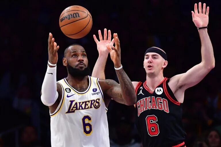 Mar 26, 2023; Los Angeles, California, USA; dLos Angeles Lakers forward LeBron James (6) plays for the ball against Chicago Bulls guard Alex Caruso (6) uring the first half at Crypto.com Arena. Mandatory Credit: Gary A. Vasquez-USA TODAY Sports