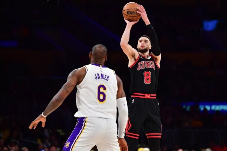 Mar 26, 2023; Los Angeles, California, USA; Chicago Bulls guard Zach LaVine (8) shoots against Los Angeles Lakers forward LeBron James (6) during the second half at Crypto.com Arena. Mandatory Credit: Gary A. Vasquez-USA TODAY Sports