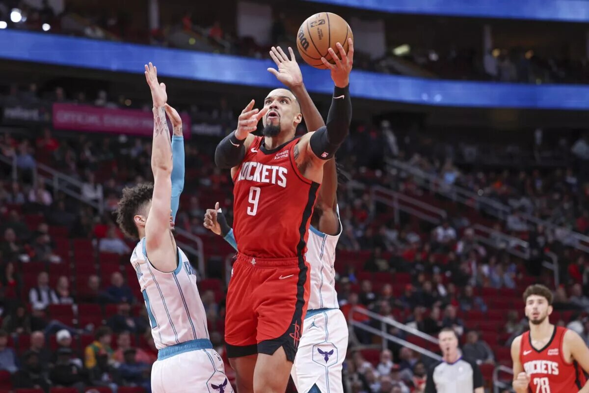Houston Rockets forward Dillon Brooks (9) shoots the ball as Charlotte Hornets guard LaMelo Ball (1) defends during the third quarter at Toyota Center.