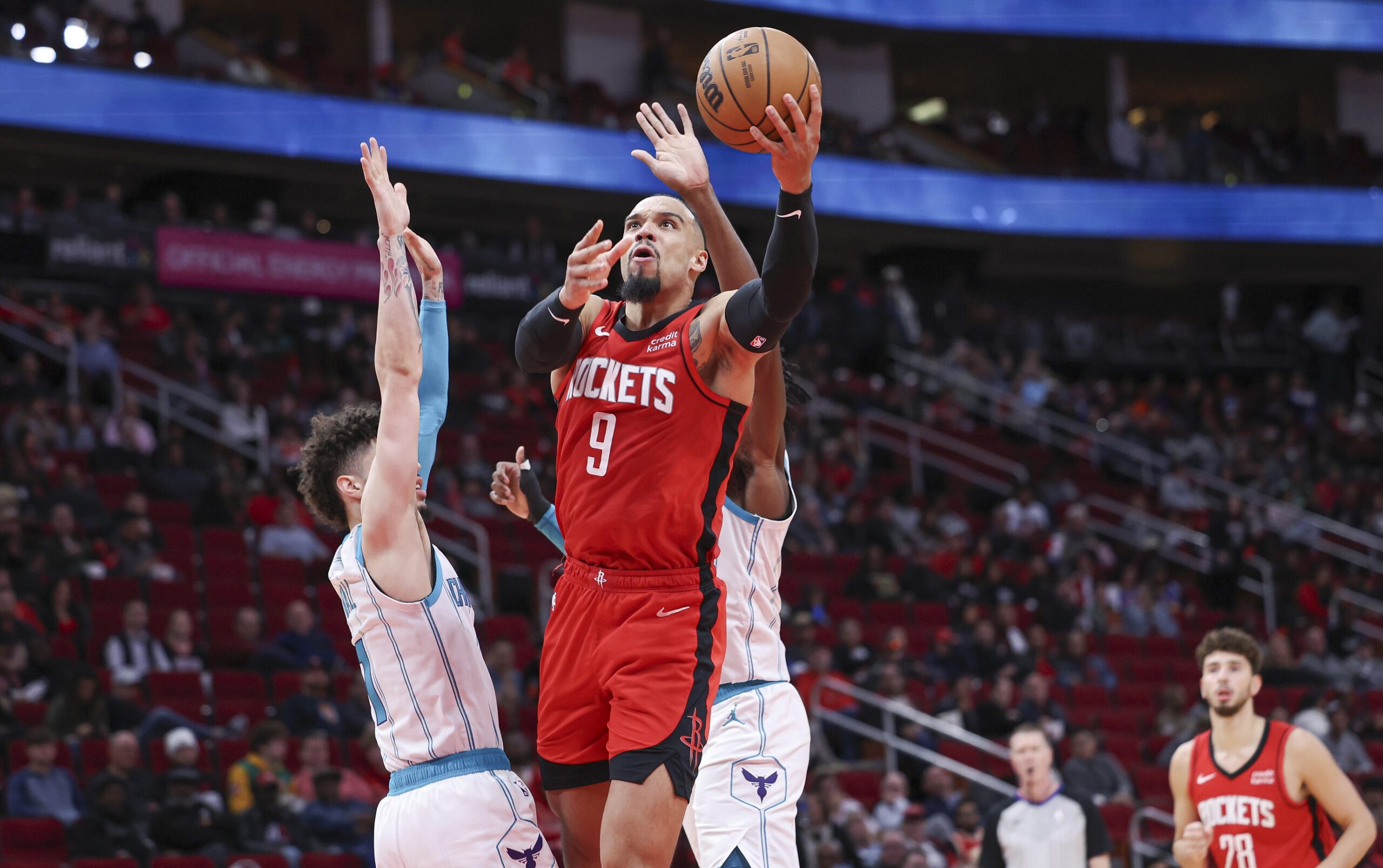 Houston Rockets forward Dillon Brooks (9) shoots the ball as Charlotte Hornets guard LaMelo Ball (1) defends during the third quarter at Toyota Center.