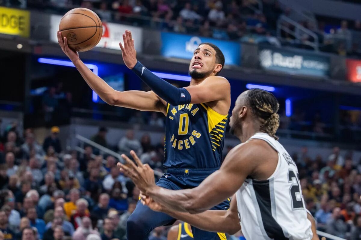 Indiana Pacers guard Tyrese Haliburton (0) shoots the ball while San Antonio Spurs guard Malaki Branham (22) defends in the first quarter at Gainbridge Fieldhouse.