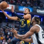 Indiana Pacers guard Tyrese Haliburton (0) shoots the ball while San Antonio Spurs guard Malaki Branham (22) defends in the first quarter at Gainbridge Fieldhouse.