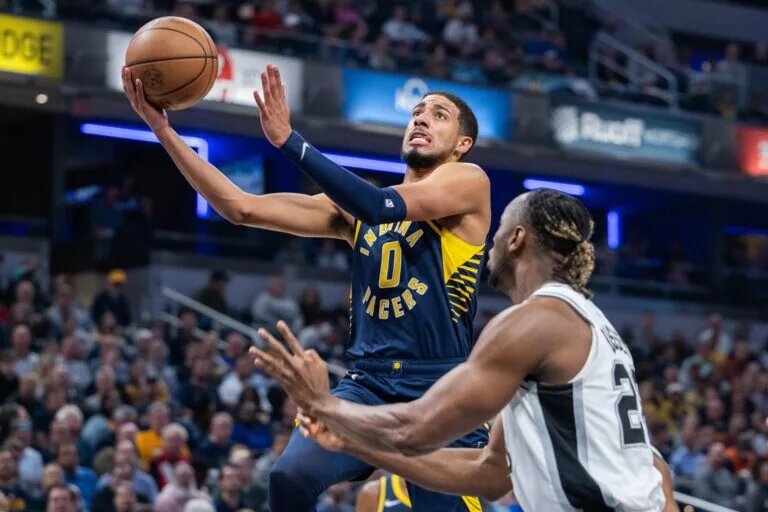 Indiana Pacers guard Tyrese Haliburton (0) shoots the ball while San Antonio Spurs guard Malaki Branham (22) defends in the first quarter at Gainbridge Fieldhouse.