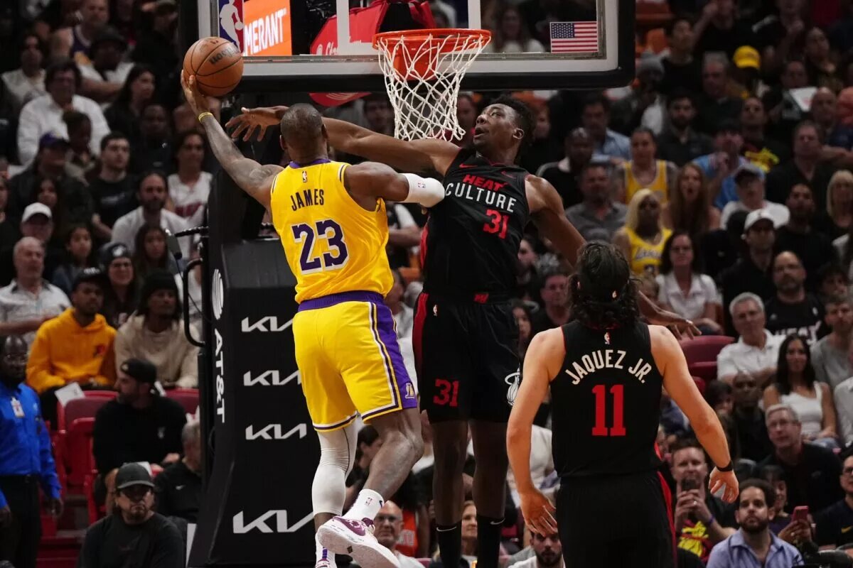 Nov 6, 2023; Miami, Florida, USA; Los Angeles Lakers forward LeBron James (23) shoots the ball around Miami Heat center Thomas Bryant (31) during the first half at Kaseya Center. Mandatory Credit: Jasen Vinlove-USA TODAY Sports