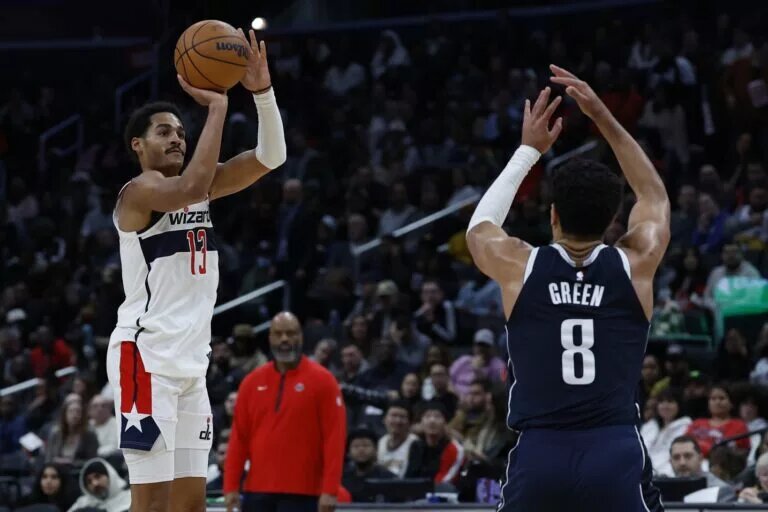 Nov 15, 2023; Washington, District of Columbia, USA; Washington Wizards guard Jordan Poole (13) shoots the ball over Dallas Mavericks guard Josh Green (8) in the third quarter at Capital One Arena. Mandatory Credit: Geoff Burke-USA TODAY Sports