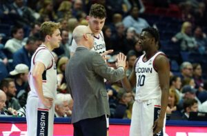 UConn Huskies head coach Dan Hurley talks with guard Hassan Diarra (10), center Donovan Clingan (32) AND guard Cam Spencer (12) from the sideline as they take on the New Hampshire Wildcats at Harry A. Gampel Pavilion.