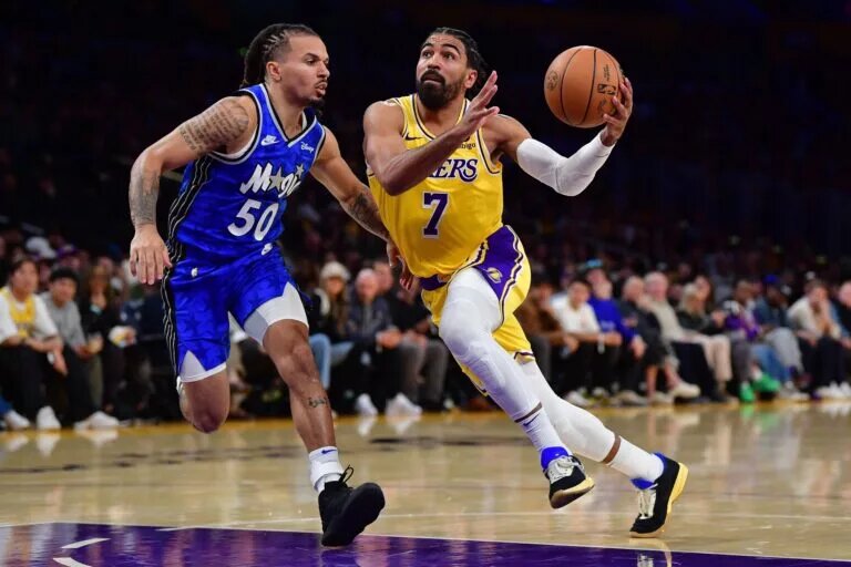 Oct 30, 2023; Los Angeles, California, USA; Los Angeles Lakers guard Gabe Vincent (7) moves to the basket against Orlando Magic guard Cole Anthony (50) during the second half at Crypto.com Arena. Mandatory Credit: Gary A. Vasquez-USA TODAY Sports