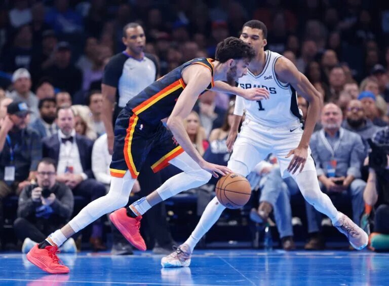 Oklahoma City Thunder forward Chet Holmgren (7) drives past San Antonio Spurs center Victor Wembanyama (1) during the second quarter at Paycom Center.