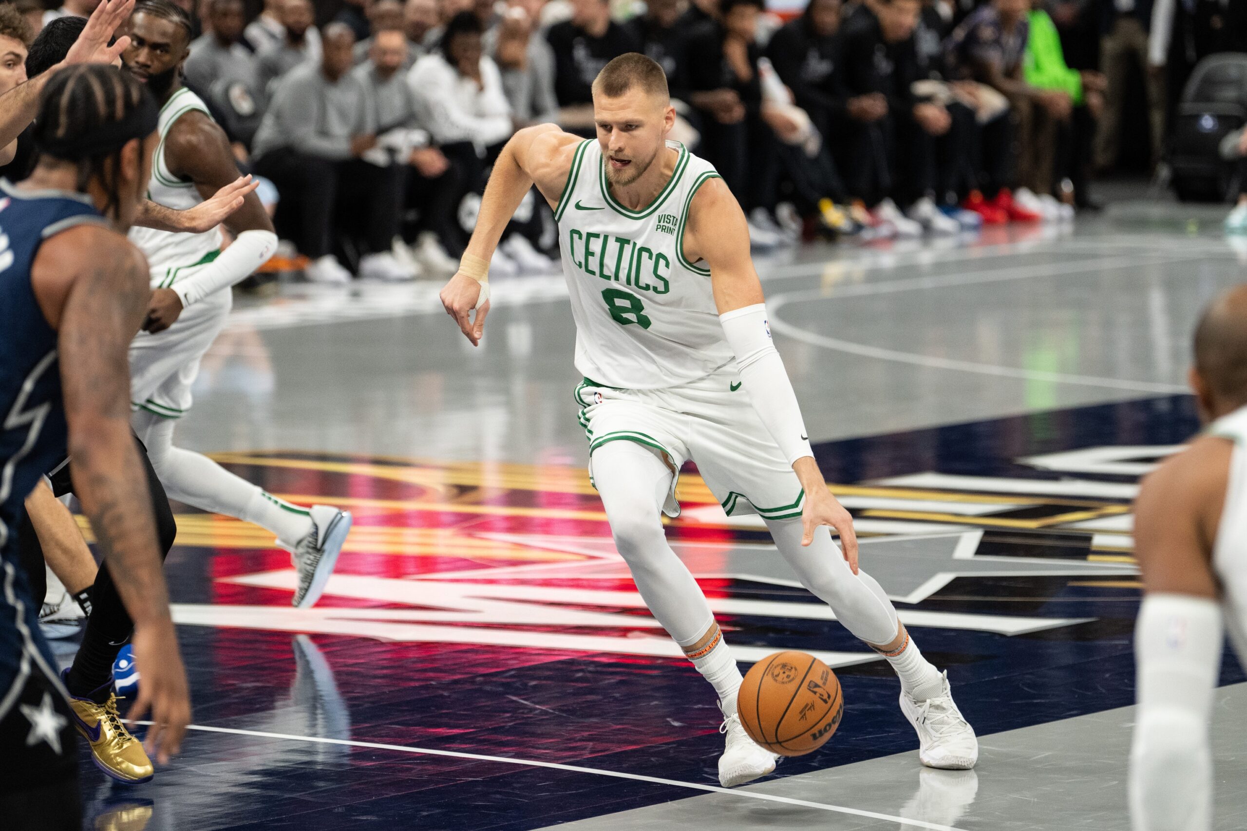 Boston Celtics forward Kristaps Porzingis (8) dribbles the ball against the Orlando Magic in the first quarter at Amway Center.