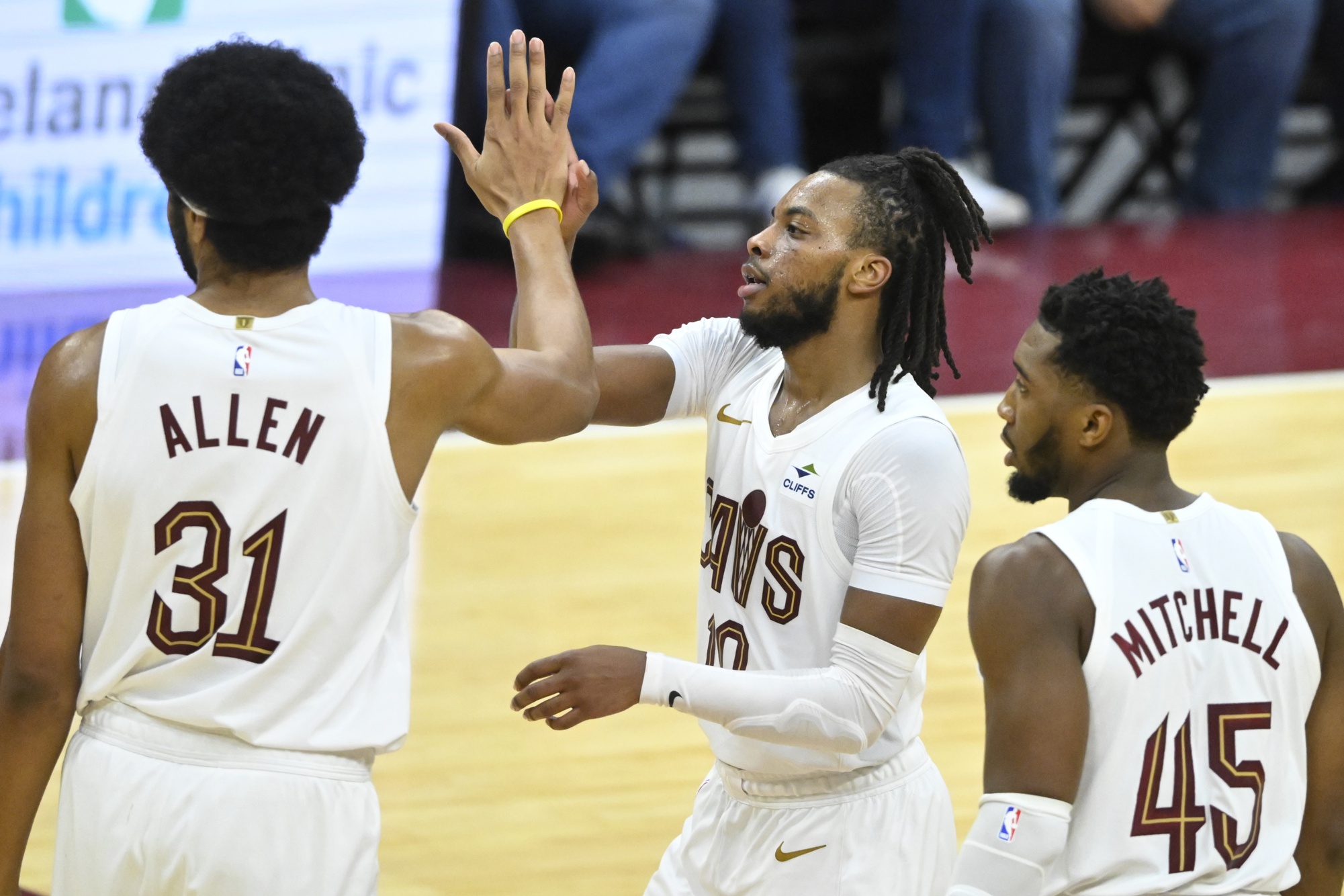 Cleveland Cavaliers center Jarrett Allen (31), guard Darius Garland (10), and guard Donovan Mitchell (45) celebrate in the fourth quarter against the Toronto Raptors at Rocket Mortgage FieldHouse.