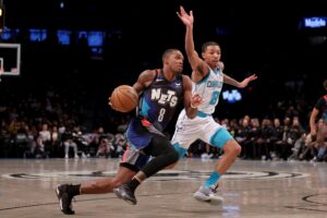 Nov 30, 2023; Brooklyn, New York, USA; Brooklyn Nets guard Lonnie Walker IV (8) drives to the basket against Charlotte Hornets guard Nick Smith Jr. (8) during the second quarter at Barclays Center. Mandatory Credit: Brad Penner-USA TODAY Sports