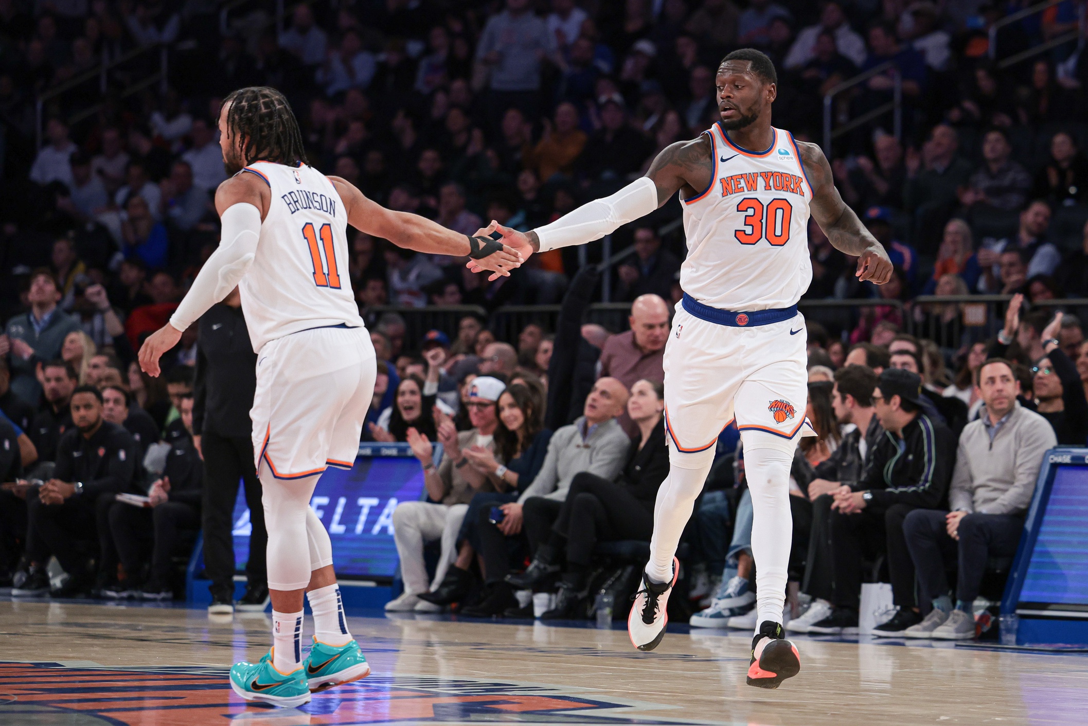 New York Knicks forward Julius Randle (30) slaps hands with guard Jalen Brunson (11) after a basket during the second half against the Detroit Pistons at Madison Square Garden.