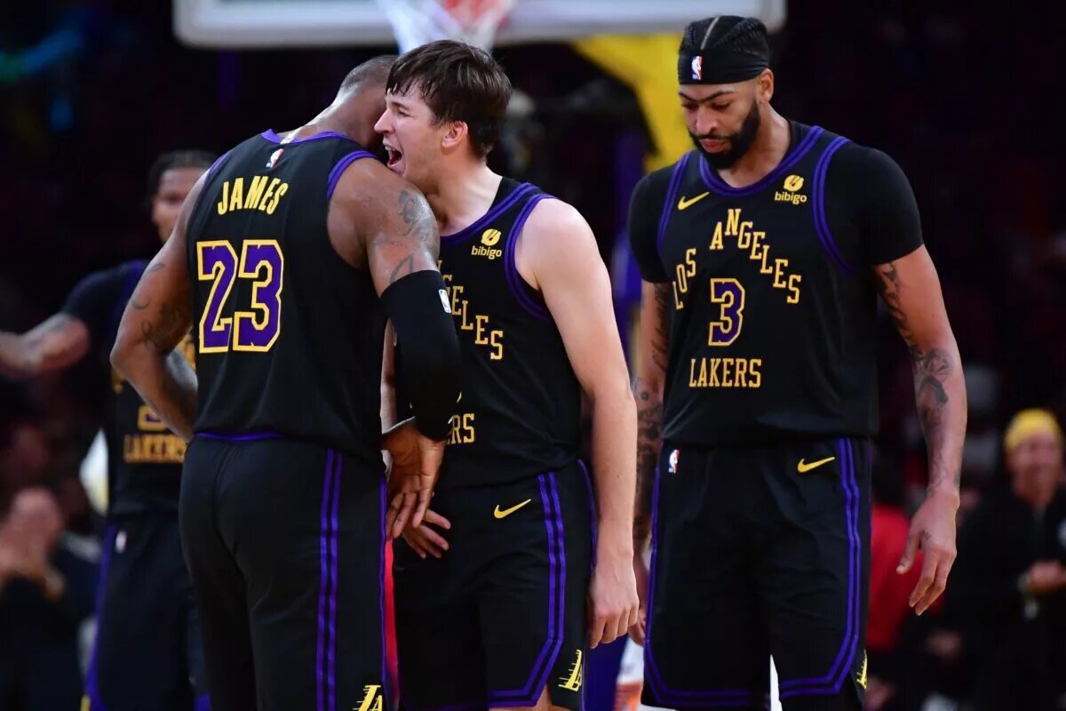 Dec 5, 2023; Los Angeles, California, USA; Los Angeles Lakers guard Austin Reaves (15) reacts after scoring three point basket against the Phoenix Suns with forward LeBron James (23) and forward Anthony Davis (3) during the second half of the In Season Tournament quarterfinal at Crypto.com Arena. Mandatory Credit: Gary A. Vasquez-USA TODAY Sports