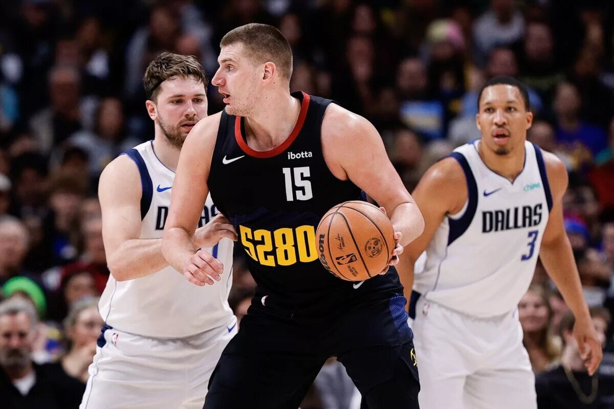 Dec 18, 2023; Denver, Colorado, USA; Denver Nuggets center Nikola Jokic (15) controls the ball as Dallas Mavericks guard Luka Doncic (77) guards in the third quarter at Ball Arena. Mandatory Credit: Isaiah J. Downing-USA TODAY Sports