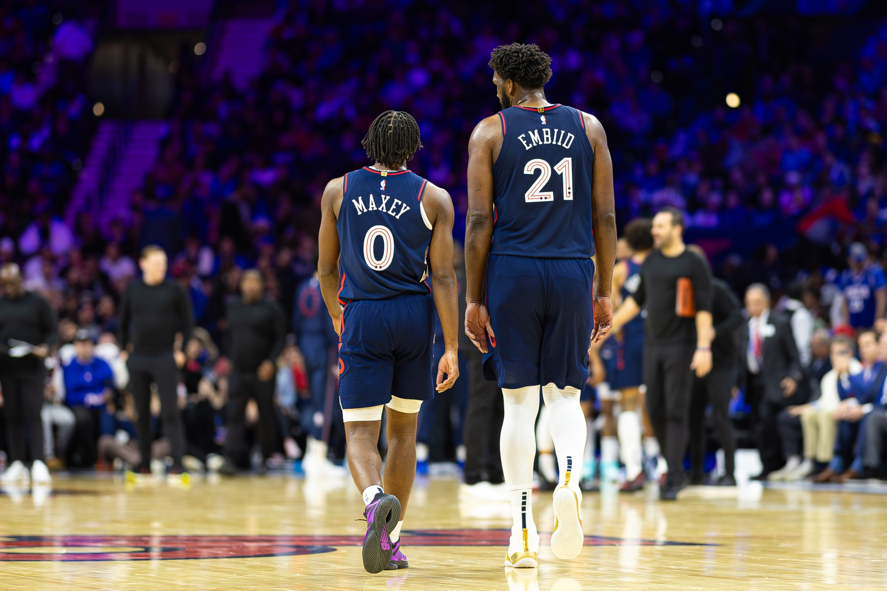 Philadelphia 76ers center Joel Embiid (21) and guard Tyrese Maxey (0) during a timeout in the second quarter against the Minnesota Timberwolves at Wells Fargo Center.