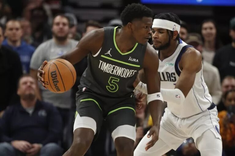 Minnesota Timberwolves guard Anthony Edwards (5) works around Dallas Mavericks guard Jaden Hardy (1) in the first quarter at Target Center.