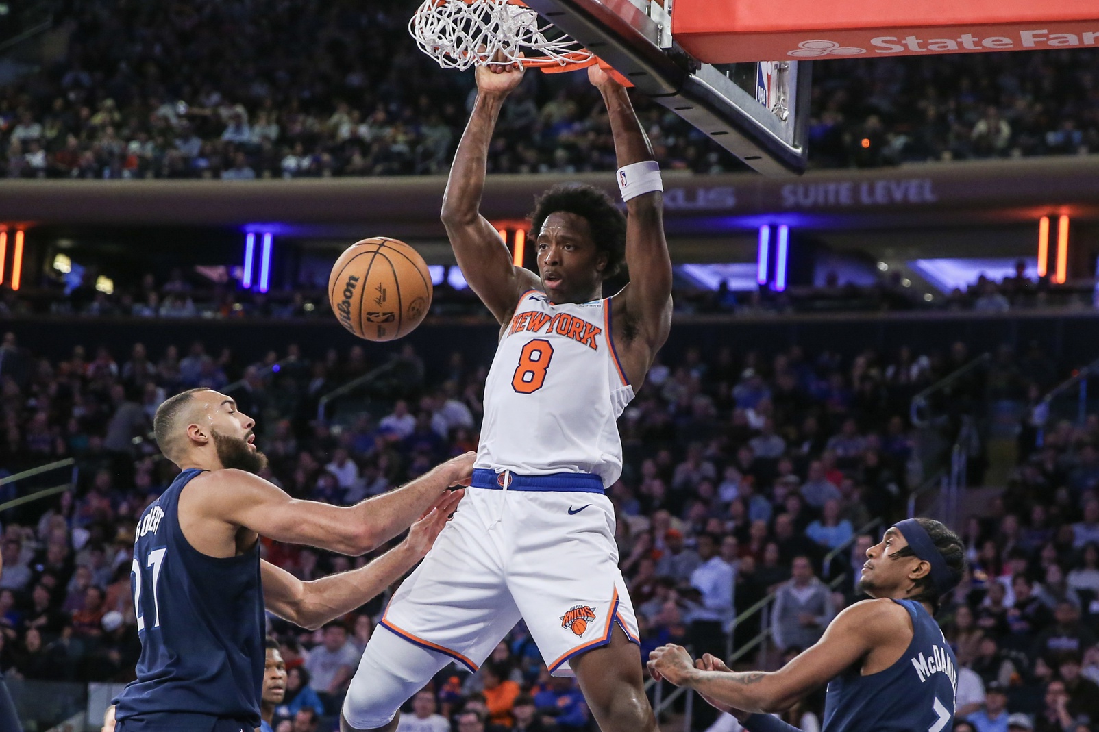 New York Knicks forward OG Anunoby (8) dunks past Minnesota Timberwolves center Rudy Gobert (27) in the third quarter at Madison Square Garden.
