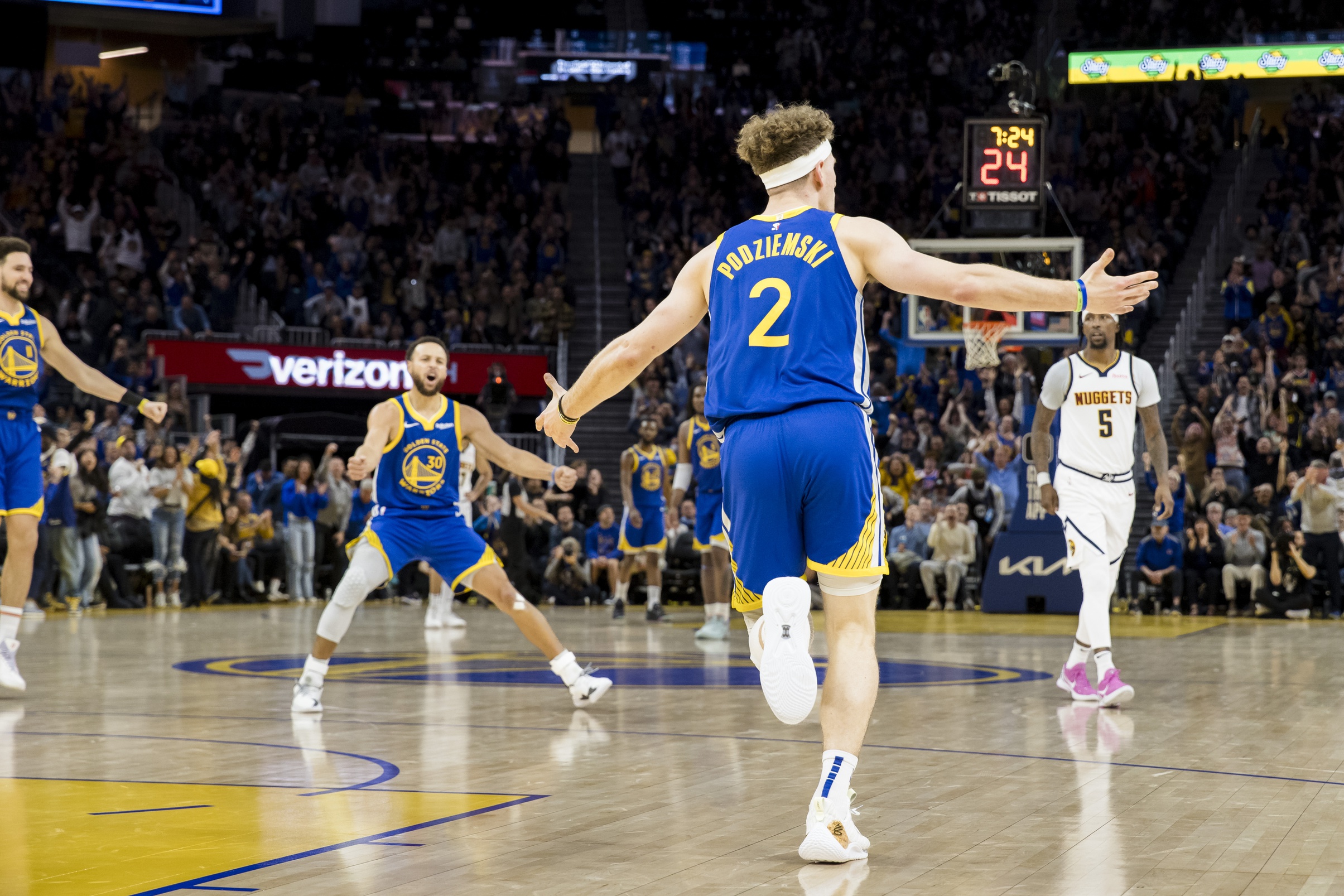 Golden State Warriors guard Brandin Podziemski (2) celebrates with forward Klay Thompson (11) and guard Stephen Curry (30) after he scored against the Denver Nuggets during the second half at Chase Center.
