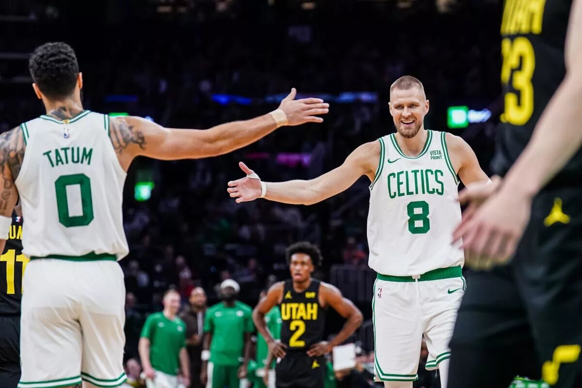 Boston Celtics center Kristaps Porzingis (8) and forward Jayson Tatum (0) react after a play against the Utah Jazz in the second quarter at TD Garden.