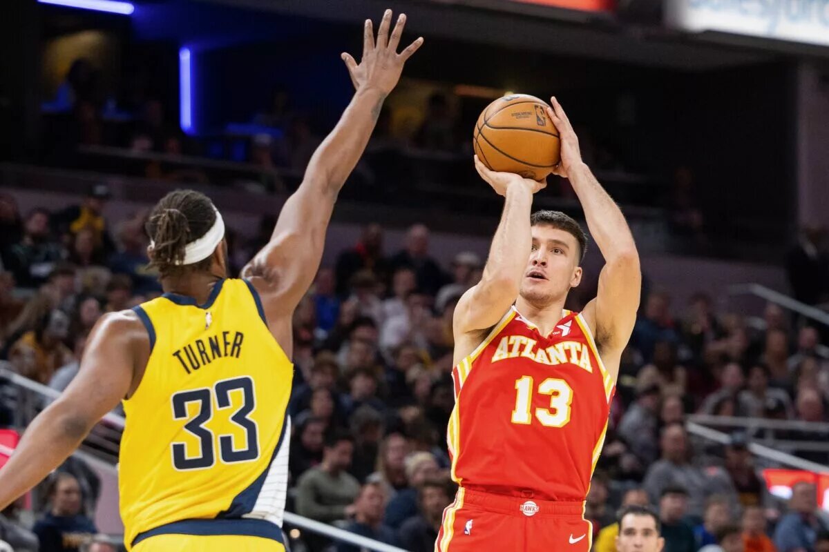 Jan 5, 2024; Indianapolis, Indiana, USA; Atlanta Hawks guard Bogdan Bogdanovic (13) shoots the ball while Indiana Pacers center Myles Turner (33) defends in the second half at Gainbridge Fieldhouse. Mandatory Credit: Trevor Ruszkowski-USA TODAY Sports