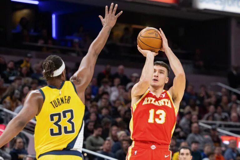 Jan 5, 2024; Indianapolis, Indiana, USA; Atlanta Hawks guard Bogdan Bogdanovic (13) shoots the ball while Indiana Pacers center Myles Turner (33) defends in the second half at Gainbridge Fieldhouse. Mandatory Credit: Trevor Ruszkowski-USA TODAY Sports