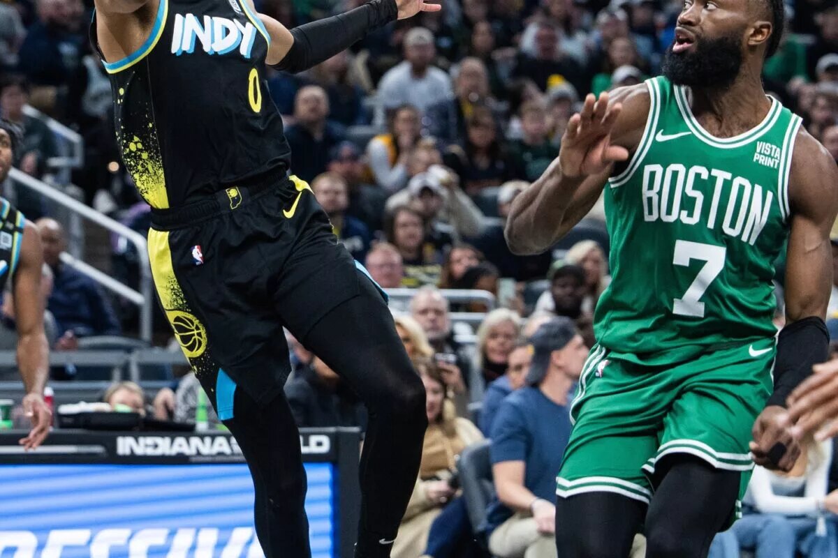 Indiana Pacers guard Tyrese Haliburton (0) shoots the ball against Boston Celtics guard Jaylen Brown (7) in the second half at Gainbridge Fieldhouse.