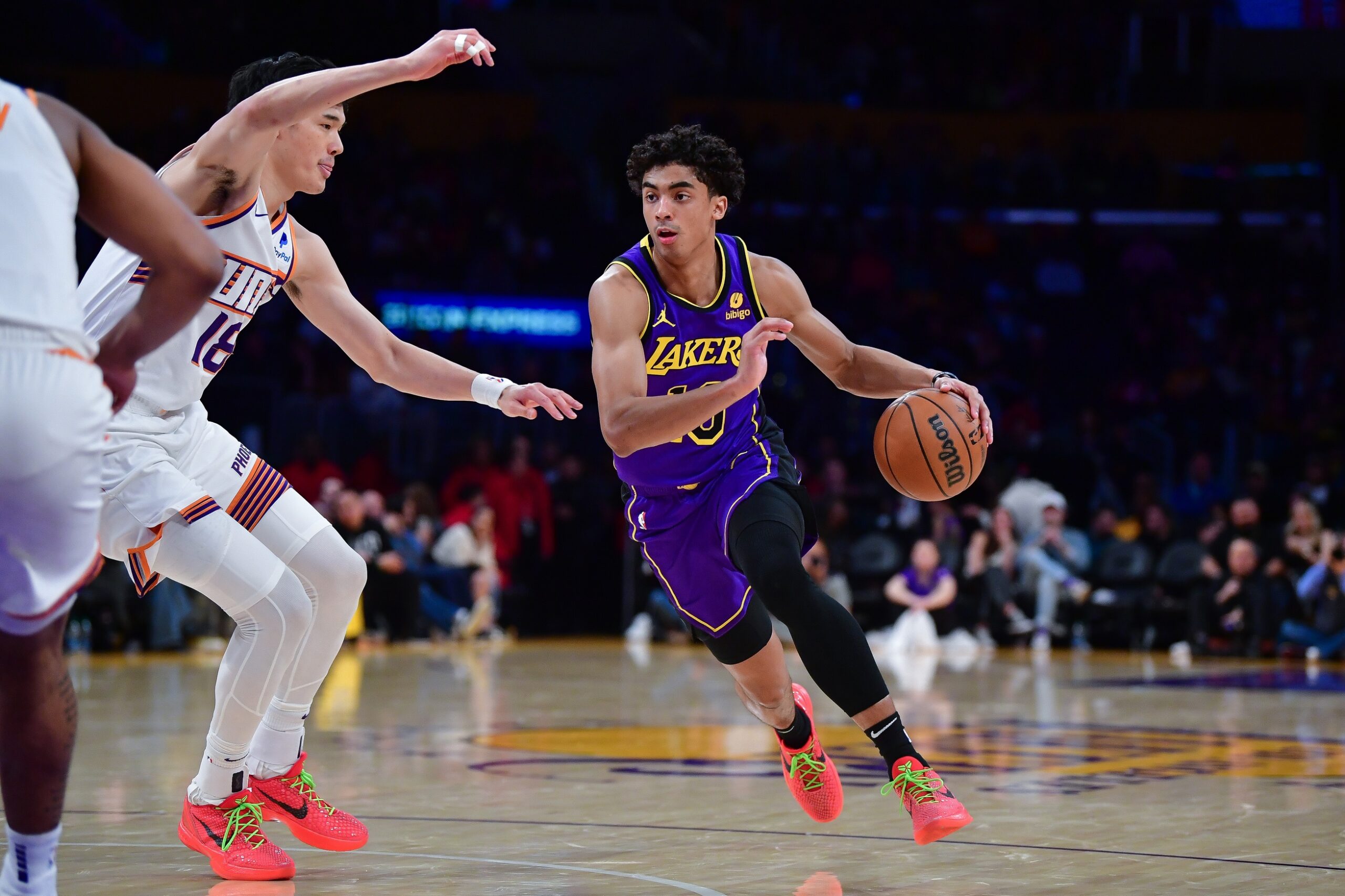 Jan 11, 2024; Los Angeles, California, USA; Los Angeles Lakers guard Max Christie (10) moves the ball against Phoenix Suns forward Yuta Watanabe (18) during the second half at Crypto.com Arena. Mandatory Credit: Gary A. Vasquez-USA TODAY Sports