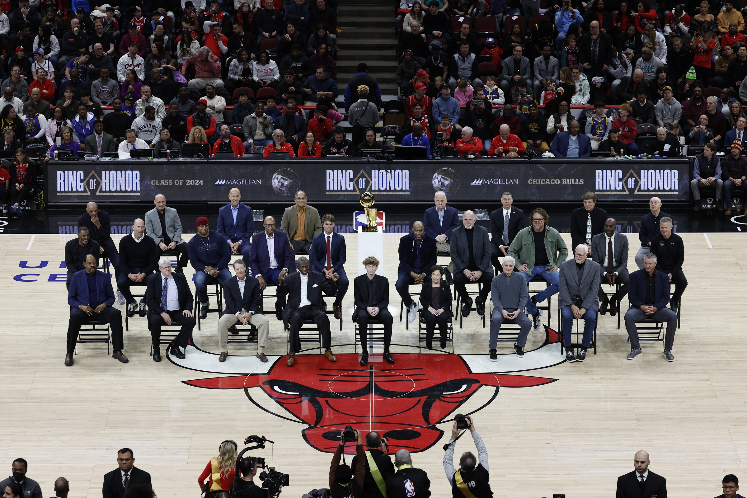 Chicago Bulls class of 2024 Ring of Honor inductees from left to right, (Back Row) Jim Cleamons, Erik Heiland, Ivika Duran, Clarence Gaines, Jr., John Ligmanowski, Chip Schaefer, Jim Stack, Al Vermeil (Middle Row) Randy Brown, Jud Buechler, Jason Coffey, James Edwards, Jack Haley, Jr., Ron Harper, Bill Wennington, Luc Longley, John Salley, Steve Kerr (Front Row) Artis Gilmore, Matt Kerr, Greg Klein, Bob Love, JJ Parrish, Thelma Krause, Chris Winter, Phil Jackson, Toni Kukoc are honored during the inaugural ceremony at halftime of a game between the Bulls and Golden State Warriors at United Center.