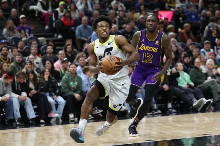 Jan 13, 2024; Salt Lake City, Utah, USA; Utah Jazz guard Collin Sexton (2) dribbles past Los Angeles Lakers forward Taurean Prince (12) during the fourth quarter at Delta Center. Mandatory Credit: Rob Gray-USA TODAY Sports
