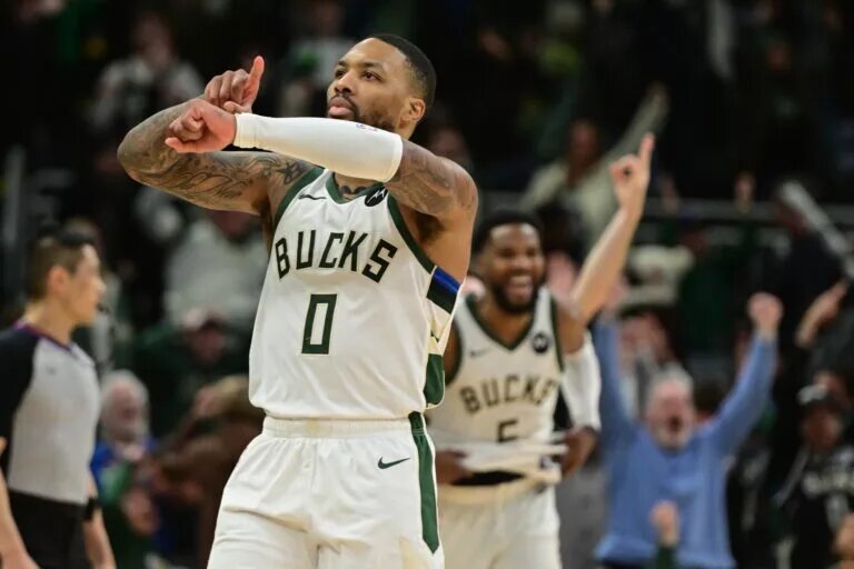 Jan 14, 2024; Milwaukee, Wisconsin, USA; Milwaukee Bucks guard Damian Lillard (0) reacts after scoring the game-winning basket in overtime against the Sacramento Kings at Fiserv Forum. Mandatory Credit: Benny Sieu-USA TODAY Sports