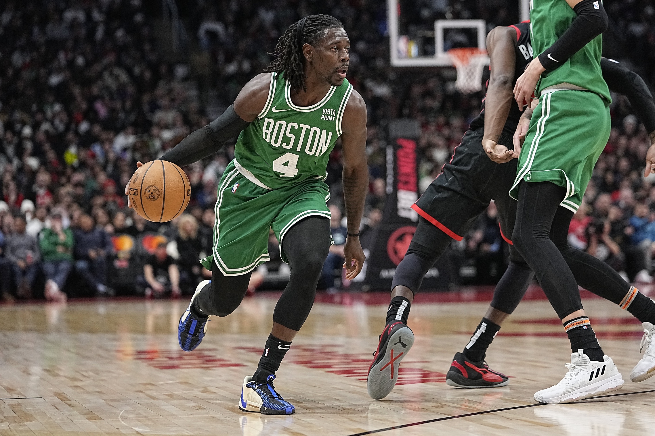 Boston Celtics guard Jrue Holiday (4) drives to the net against the Toronto Raptors during the first half at Scotiabank Arena.