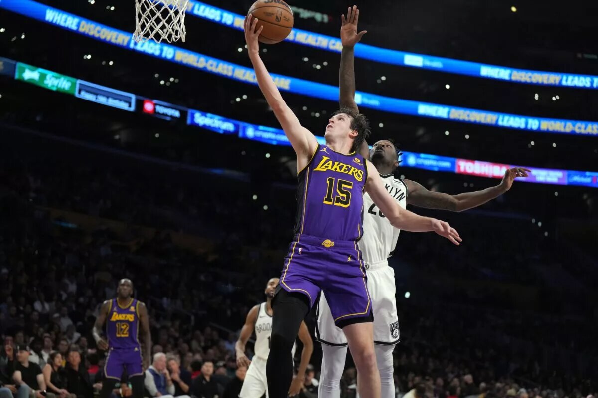 Los Angeles Lakers guard Austin Reaves (15) shoots the ball against Brooklyn Nets forward Dorian Finney-Smith (28) in the first half at Crypto.com Arena.