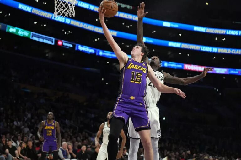 Los Angeles Lakers guard Austin Reaves (15) shoots the ball against Brooklyn Nets forward Dorian Finney-Smith (28) in the first half at Crypto.com Arena.