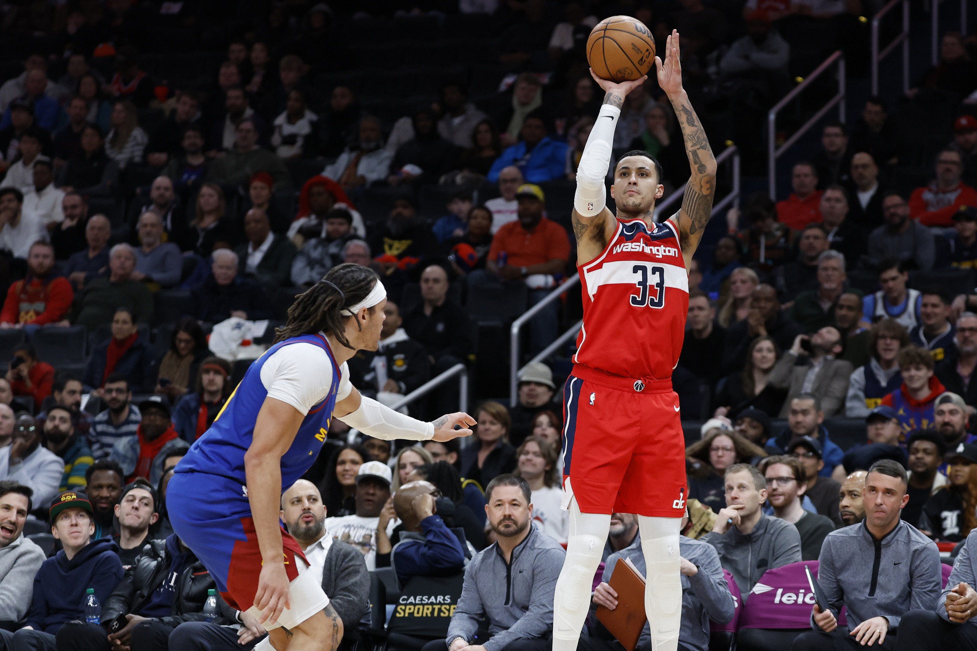 Washington Wizards forward Kyle Kuzma (33) shoots the ball as Denver Nuggets forward Aaron Gordon (50) defends in the second half at Capital One Arena.