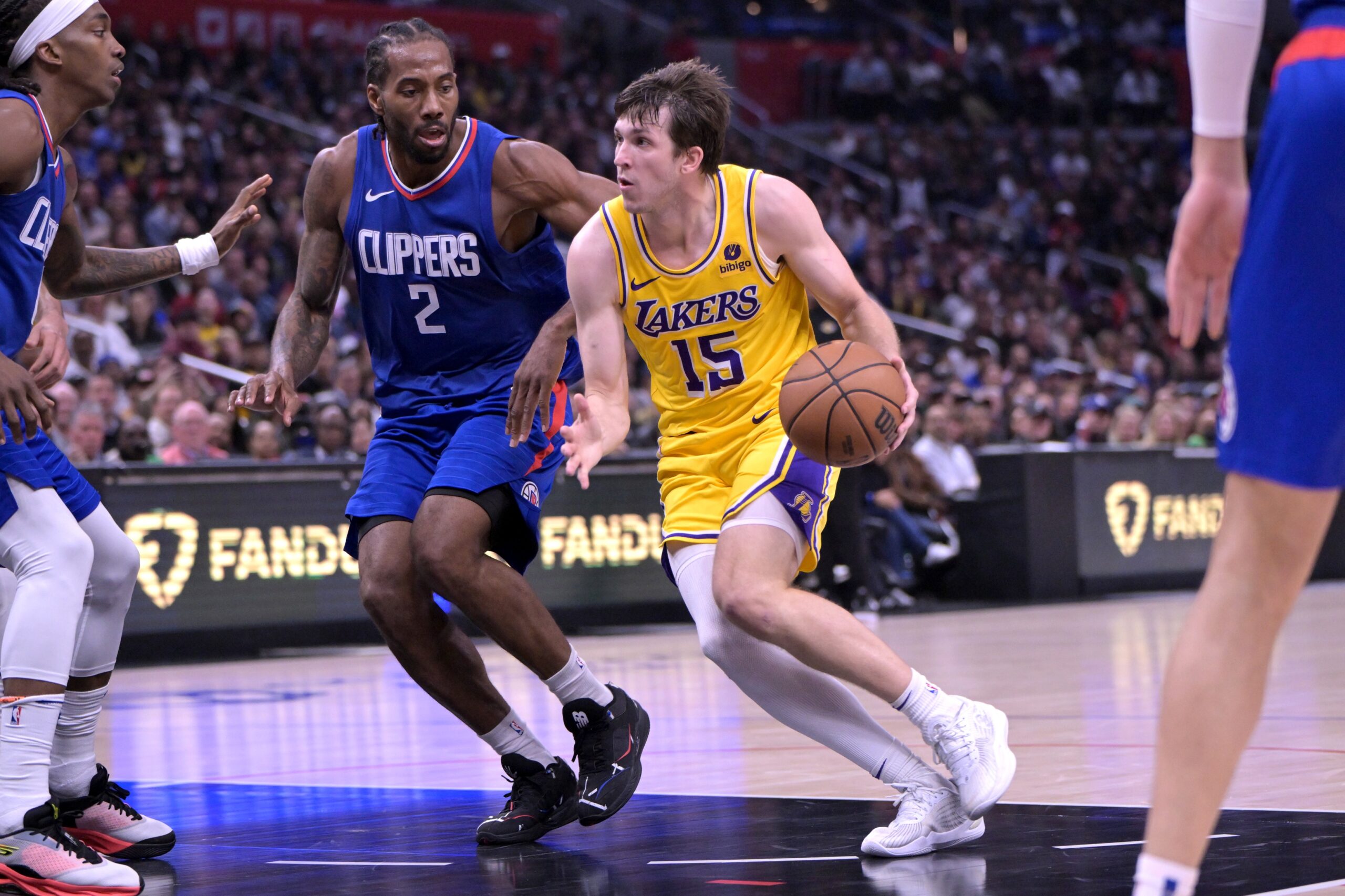 Jan 23, 2024; Los Angeles, California, USA; Los Angeles Lakers guard Austin Reaves (15) drives past Los Angeles Clippers forward Kawhi Leonard (2) for a basket in the second half at Crypto.com Arena. Mandatory Credit: Jayne Kamin-Oncea-USA TODAY Sports