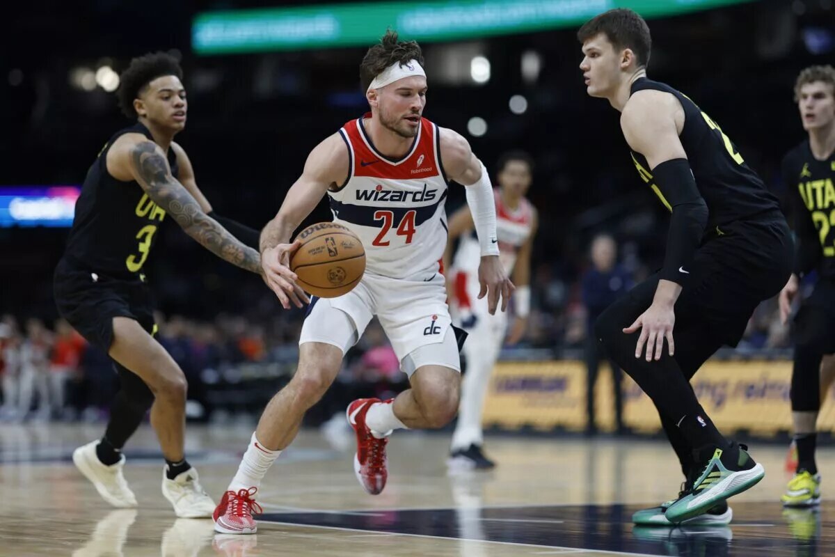 Washington Wizards forward Corey Kispert (24) drives to the basket as Utah Jazz center Walker Kessler (24) defends in the first half at Capital One Arena.