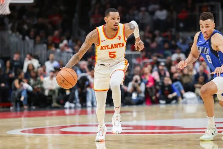 Atlanta Hawks guard Dejounte Murray (5) dribbles against the Dallas Mavericks in the second half at State Farm Arena.