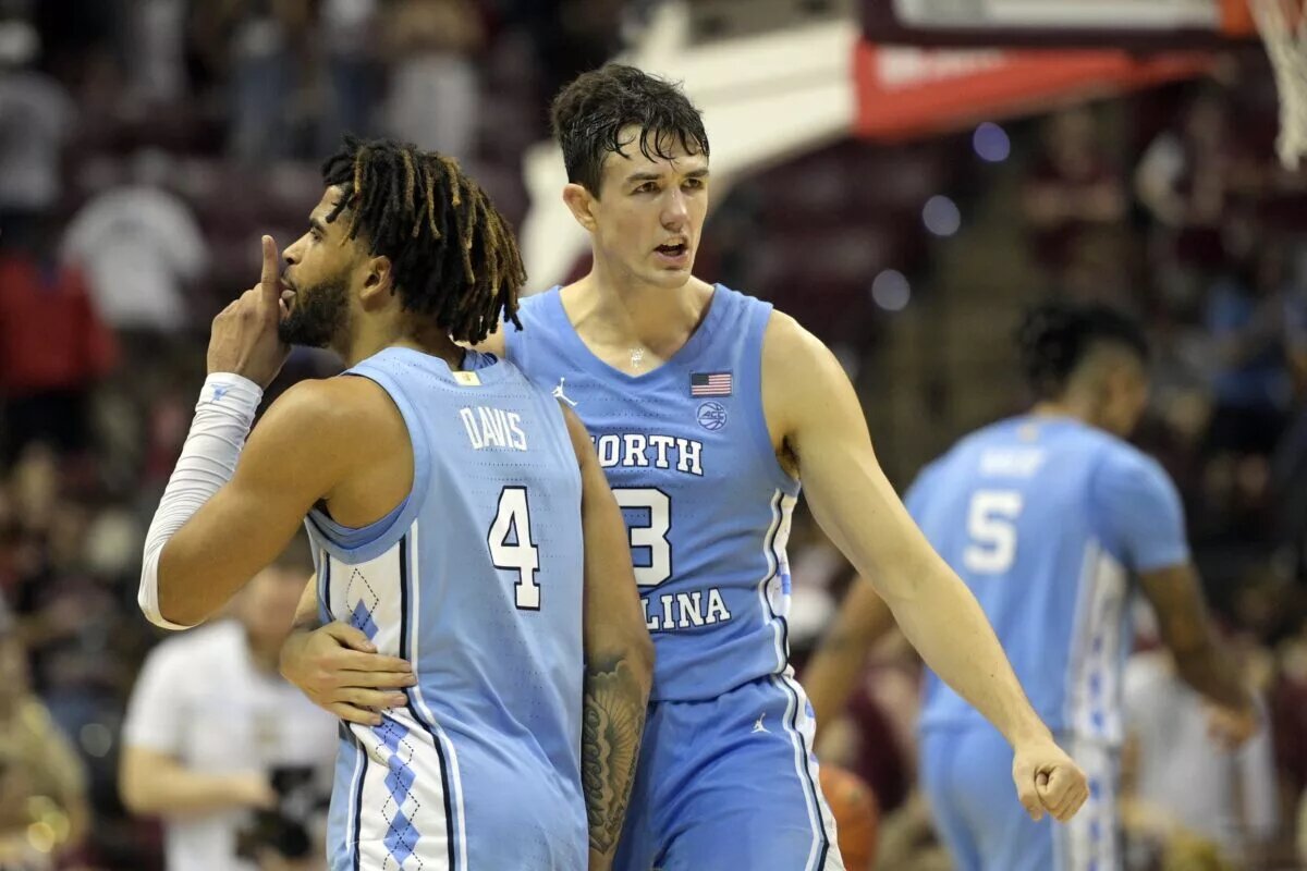 North Carolina Tarheels guard RJ Davis (4) and guard Cormac Ryan (3) celebrate after winning the game against the Florida State Seminoles at Donald L. Tucker Center.