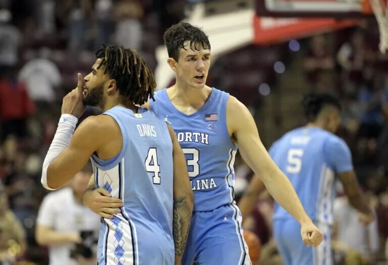 North Carolina Tarheels guard RJ Davis (4) and guard Cormac Ryan (3) celebrate after winning the game against the Florida State Seminoles at Donald L. Tucker Center.