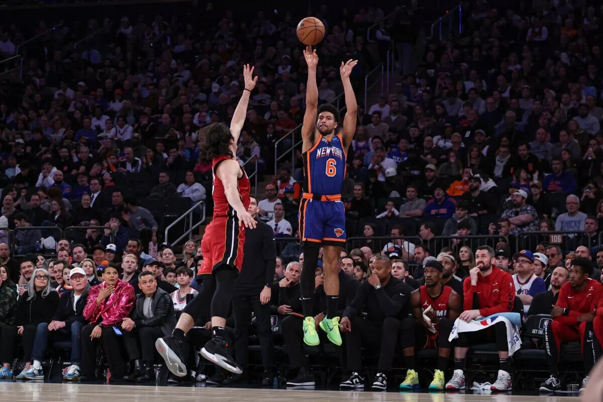 Jan 27, 2024; New York, New York, USA; New York Knicks guard Quentin Grimes (6) makes a three point basket as Miami Heat guard Jaime Jaquez Jr. (11) defends during the second half at Madison Square Garden. Mandatory Credit: Vincent Carchietta-USA TODAY Sports
