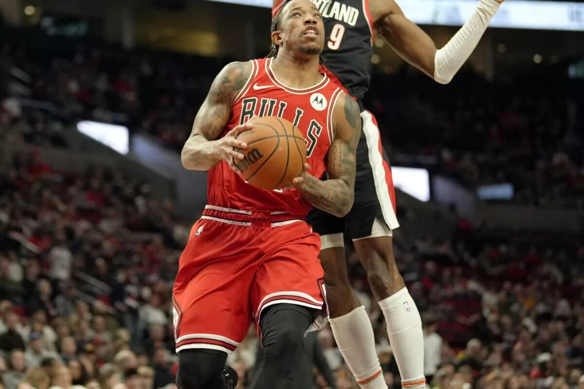 Chicago Bulls small forward DeMar DeRozan (11, left) drives to the basket under pressure from Portland Trail Blazers small forward Jerami Grant (9) during the first half at Moda Center.