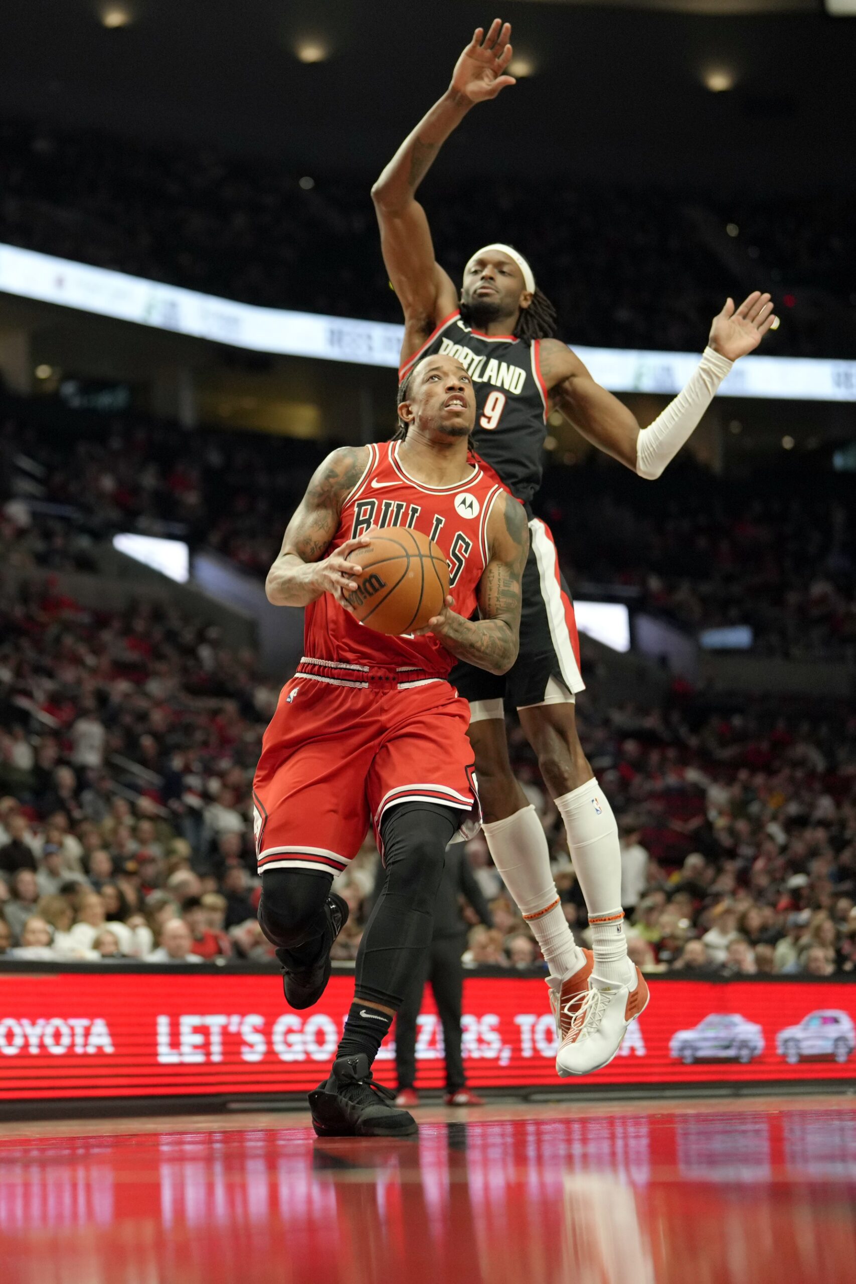 Chicago Bulls small forward DeMar DeRozan (11, left) drives to the basket under pressure from Portland Trail Blazers small forward Jerami Grant (9) during the first half at Moda Center.