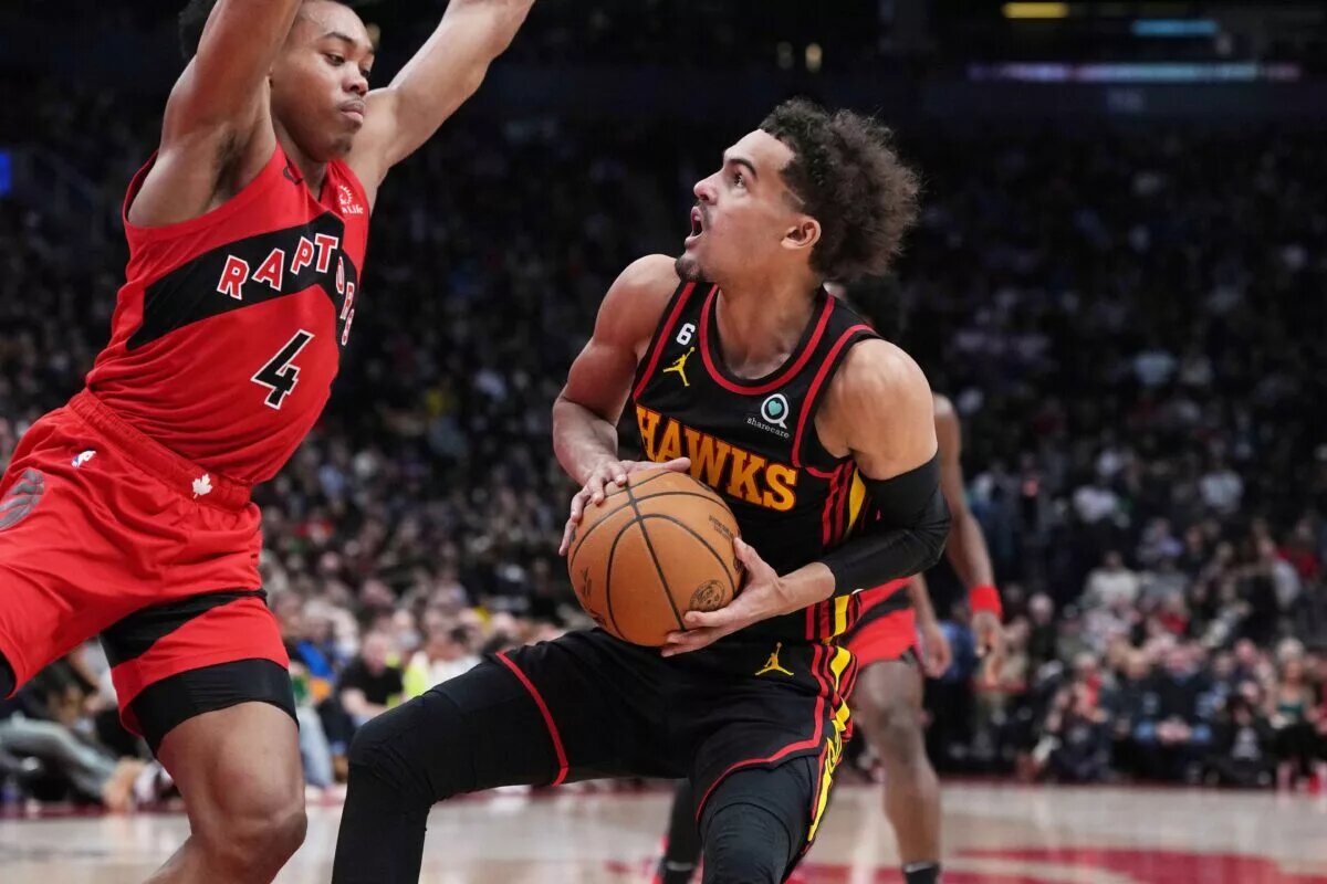 Jan 14, 2023; Toronto, Ontario, CAN; Atlanta Hawks guard Trae Young (11) controls the ball as Toronto Raptors forward Scottie Barnes (4) tries to defend during the second quarter at the Scotiabank Arena against the Toronto Raptors. Mandatory Credit: Nick Turchiaro-USA TODAY Sports