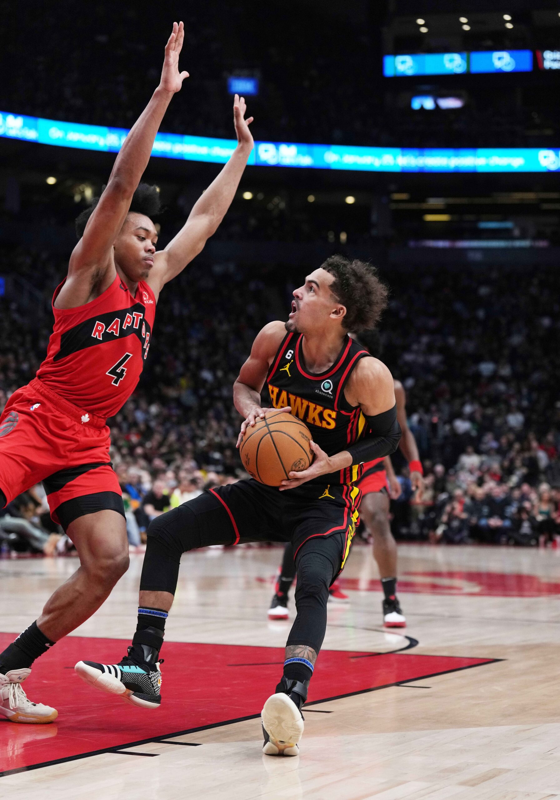 Jan 14, 2023; Toronto, Ontario, CAN; Atlanta Hawks guard Trae Young (11) controls the ball as Toronto Raptors forward Scottie Barnes (4) tries to defend during the second quarter at the Scotiabank Arena against the Toronto Raptors. Mandatory Credit: Nick Turchiaro-USA TODAY Sports