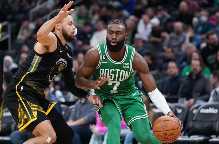 Jan 19, 2023; Boston, Massachusetts, USA; Boston Celtics guard Jaylen Brown (7) drives the ball against Golden State Warriors guard Stephen Curry (30) in the second half at TD Garden. Mandatory Credit: David Butler II-USA TODAY Sports